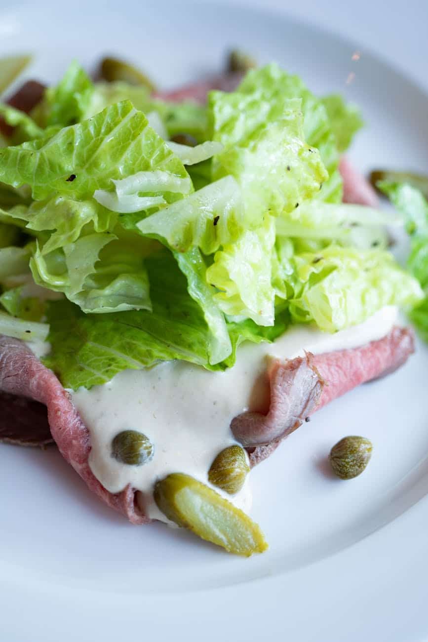 meat served with sauce and lettuce