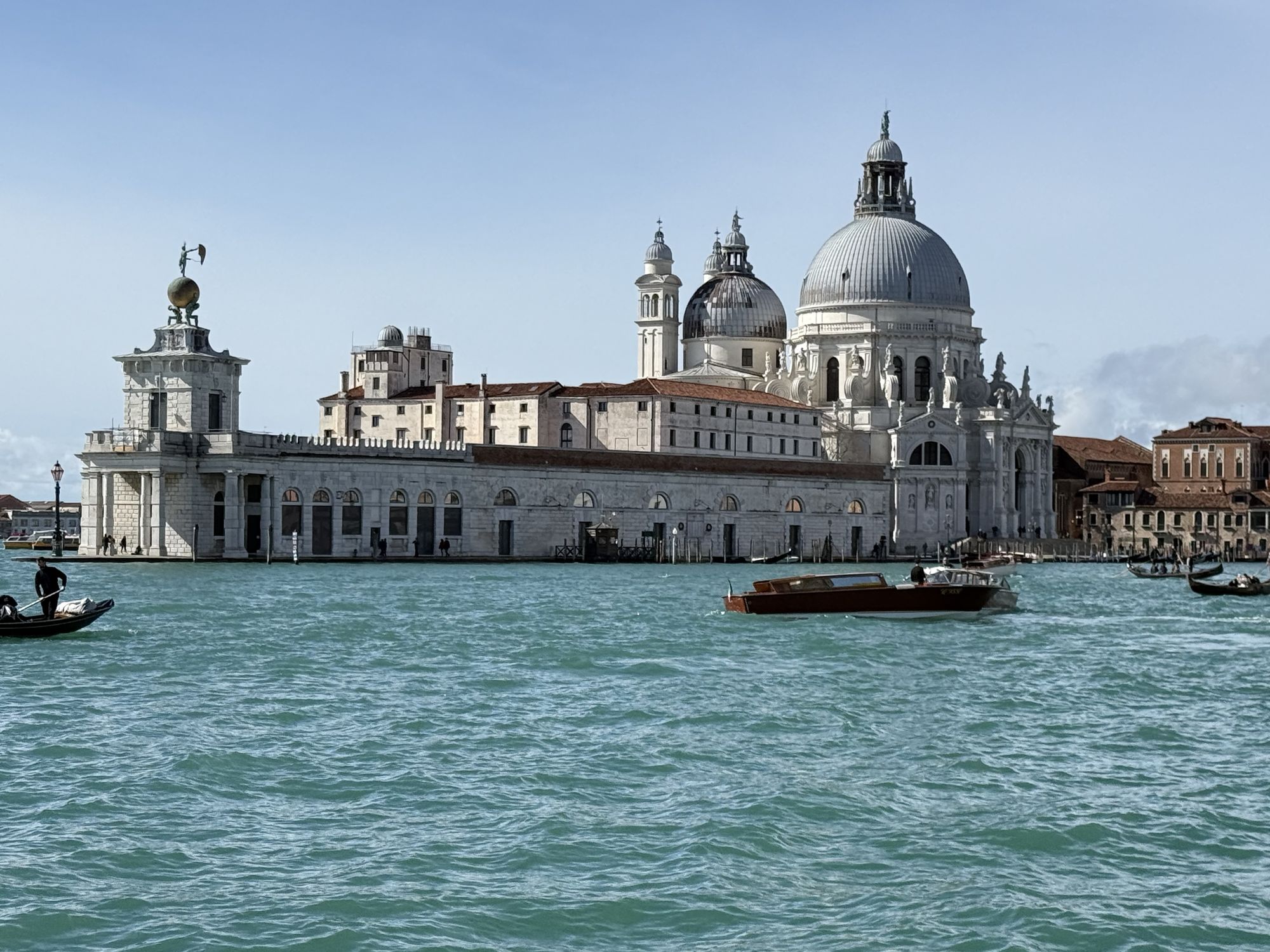 The Dogana da Mar customs house, with its golden globe and weathervane, and the dome of Santa Maria della Salute behind, seen across the water at Punta della Dogana, Venice